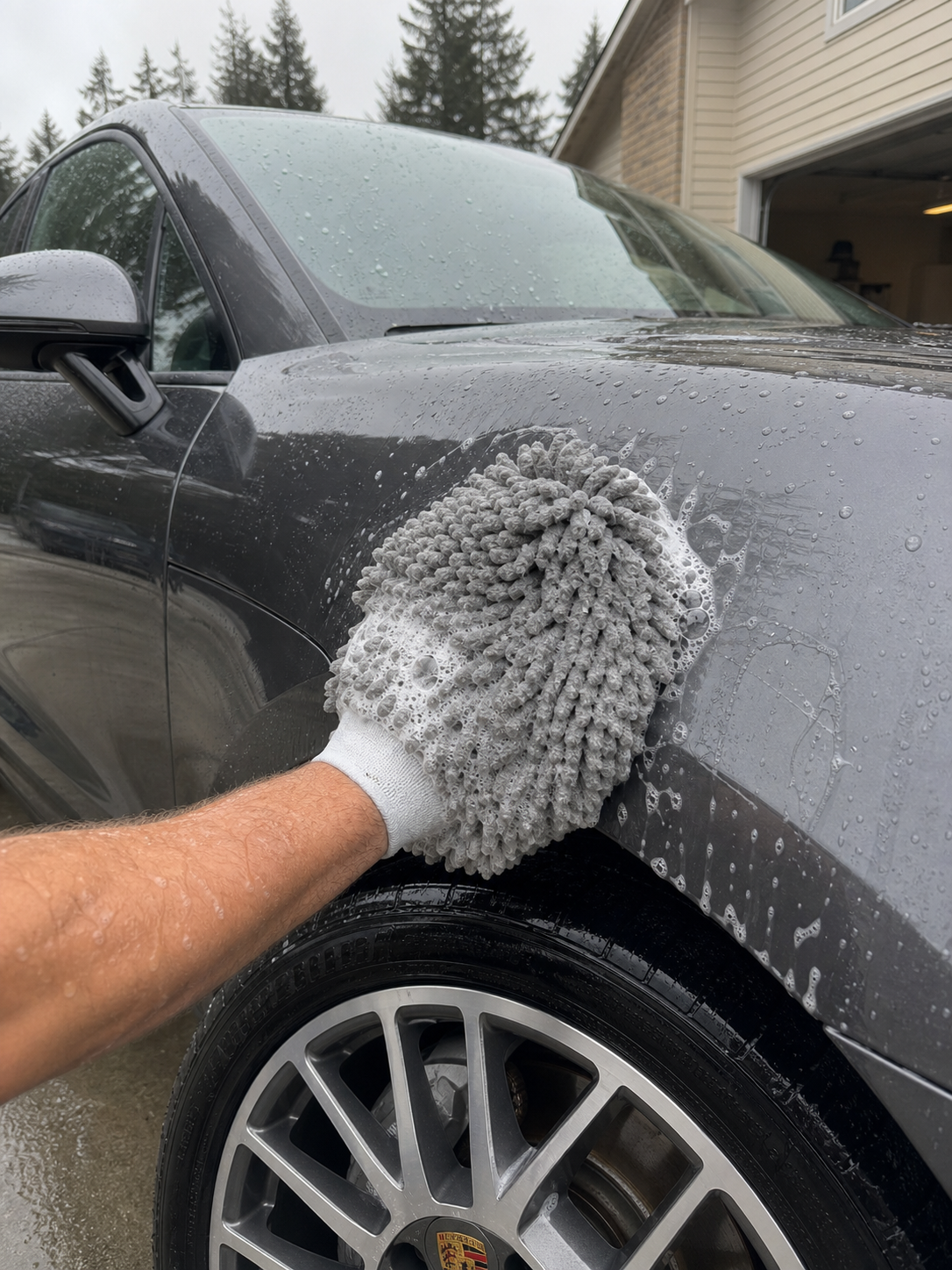 Diamond Auto Detailing technician hand-washing a Porsche Macan S with a premium microfiber mitt